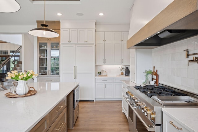 11278 Eastwood Ave SE, Delano, MN 55328 - kitchen featuring custom exhaust hood, stainless steel appliances, decorative backsplash, white cabinetry, and recessed lighting