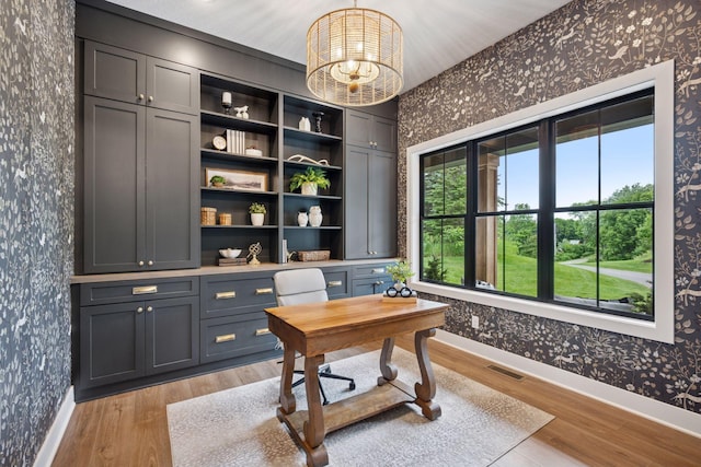 11278 Eastwood Ave SE, Delano, MN 55328 - home office featuring wallpapered walls, light wood-style flooring, healthy amount of natural light, and a chandelier