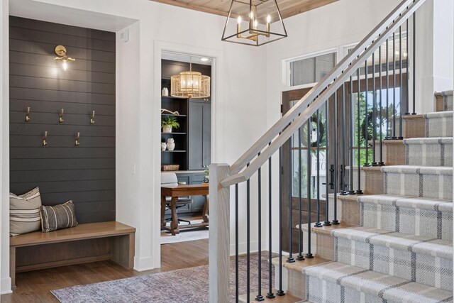 11278 Eastwood Ave SE, Delano, MN 55328 - stairs featuring wood finished floors and a chandelier