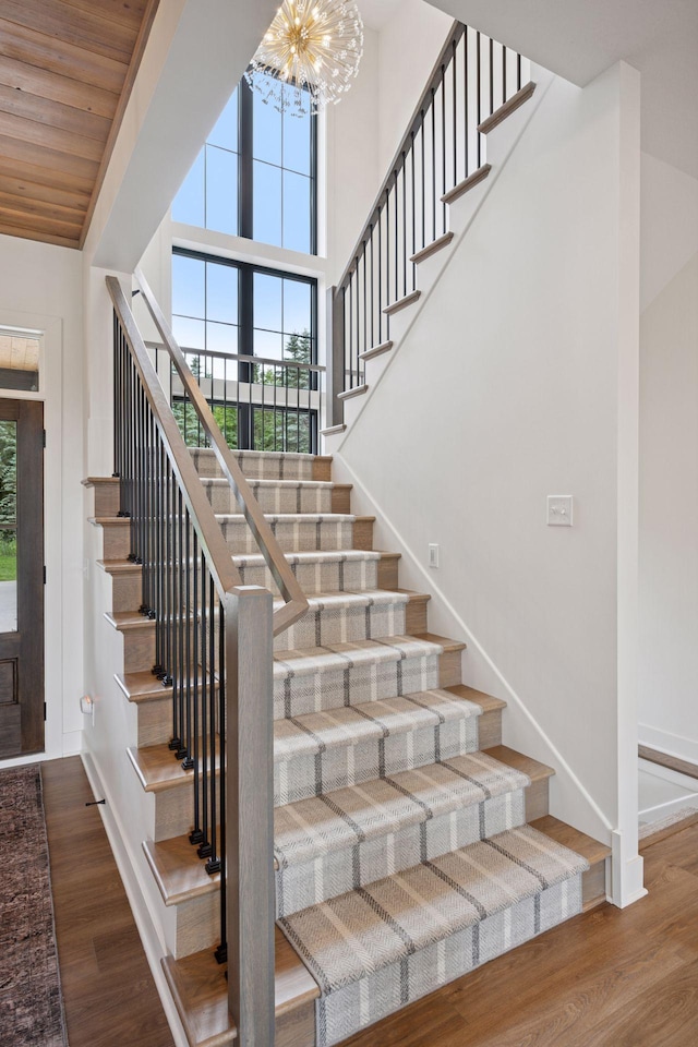 11278 Eastwood Ave SE, Delano, MN 55328 - staircase with plenty of natural light, wood finished floors, and a chandelier