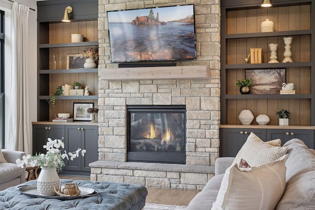 11278 Eastwood Ave SE, Delano, MN 55328 - living room with built in features, a stone fireplace, and wood finished floors