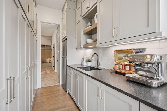 11278 Eastwood Ave SE, Delano, MN 55328 - kitchen featuring dark countertops, open shelves, light wood finished floors, and tasteful backsplash