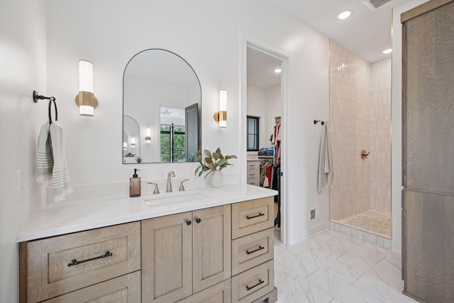 11278 Eastwood Ave SE, Delano, MN 55328 - bathroom with vanity, a walk in shower, marble finish flooring, recessed lighting, and a spacious closet