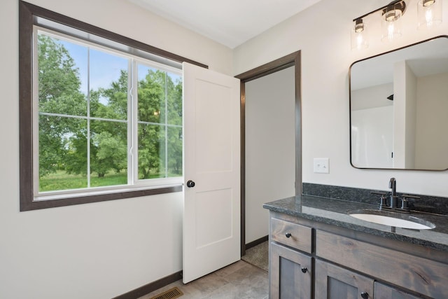 2660 128th Ave NW, Coon Rapids, MN 55434 - bathroom with vanity and baseboards