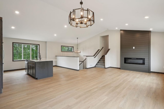2660 128th Ave NW, Coon Rapids, MN 55434 - kitchen with a sink, a chandelier, light countertops, vaulted ceiling, and dishwasher