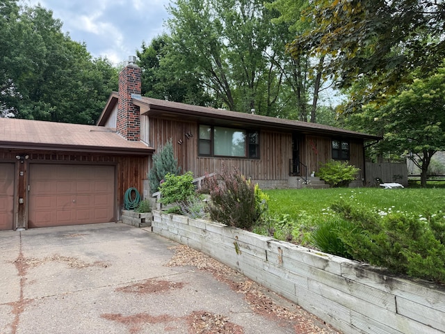 2820 Pilot Knob Rd, Eagan, MN 55121 - view of front of home with concrete driveway, a chimney, a garage, and a front yard