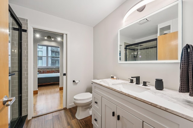 521 7th St Unit 416, Minneapolis, MN 55415 - ensuite bathroom with vanity, wood finished floors, and an enclosed shower