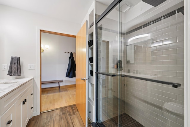 521 7th St Unit 416, Minneapolis, MN 55415 - full bath featuring a shower stall, vanity, and wood finished floors