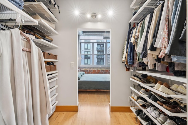 521 7th St Unit 416, Minneapolis, MN 55415 - walk in closet featuring light wood-type flooring