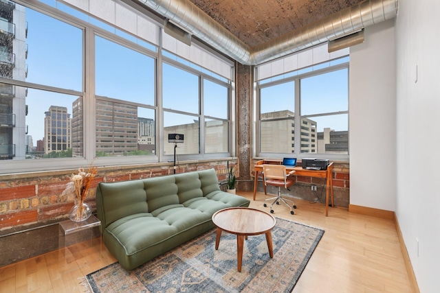 521 7th St Unit 416, Minneapolis, MN 55415 - living room featuring healthy amount of natural light, a view of city, and a desk