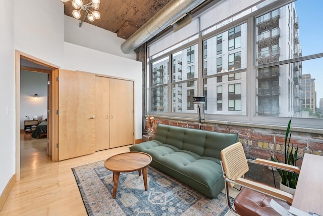521 7th St Unit 416, Minneapolis, MN 55415 - living room featuring a towering ceiling, wood finished floors, and a chandelier