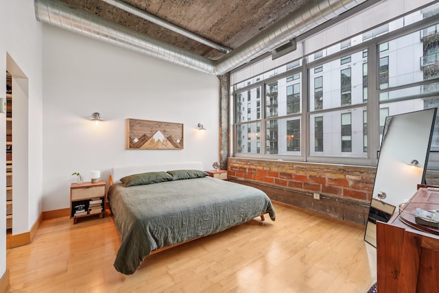 521 7th St Unit 416, Minneapolis, MN 55415 - bedroom with a towering ceiling and wood finished floors