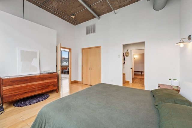 521 7th St Unit 416, Minneapolis, MN 55415 - bedroom featuring a high ceiling and wood finished floors