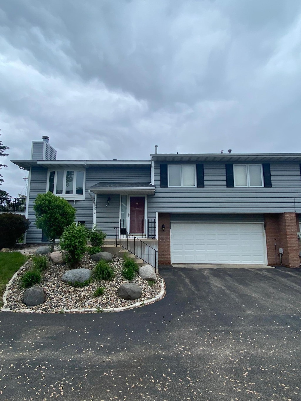 14781 Endicott Way, Apple Valley, MN 55124 - view of front of house featuring an attached garage, asphalt driveway, a chimney, and brick siding