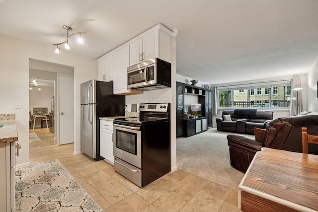 1901 Emerson Ave S Unit 104, Minneapolis, MN 55403 - kitchen with appliances with stainless steel finishes, white cabinets, open floor plan, and light stone countertops