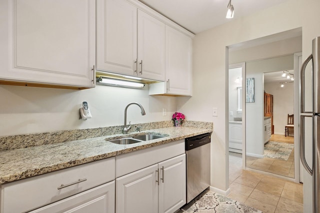 1901 Emerson Ave S Unit 104, Minneapolis, MN 55403 - kitchen featuring appliances with stainless steel finishes, white cabinetry, and light stone countertops