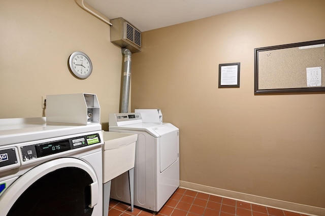 1901 Emerson Ave S Unit 104, Minneapolis, MN 55403 - laundry area with separate washer and dryer and dark tile patterned floors