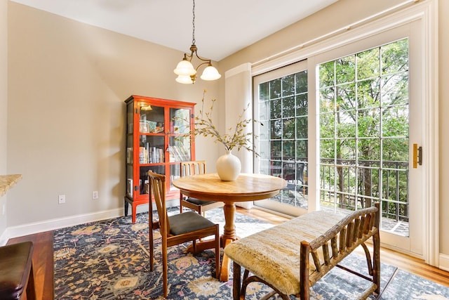 448 3rd St, Excelsior, MN 55331 - dining area with healthy amount of natural light, light wood finished floors, and a chandelier