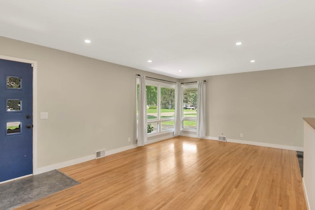 7609 65th Ave N, Brooklyn Park, MN 55428 - unfurnished living room featuring light wood-type flooring, recessed lighting, and baseboards