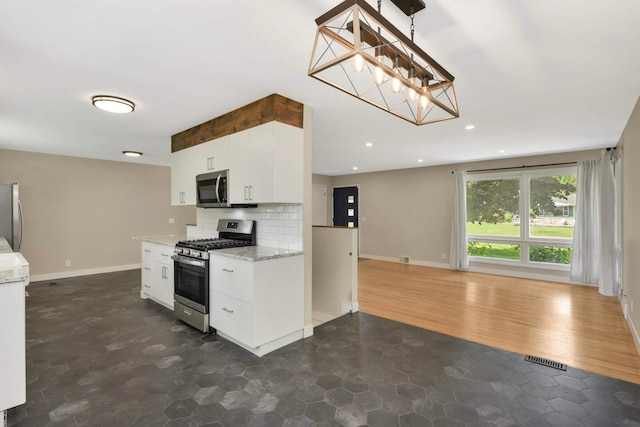 7609 65th Ave N, Brooklyn Park, MN 55428 - kitchen featuring stainless steel appliances, tasteful backsplash, white cabinets, baseboards, and recessed lighting
