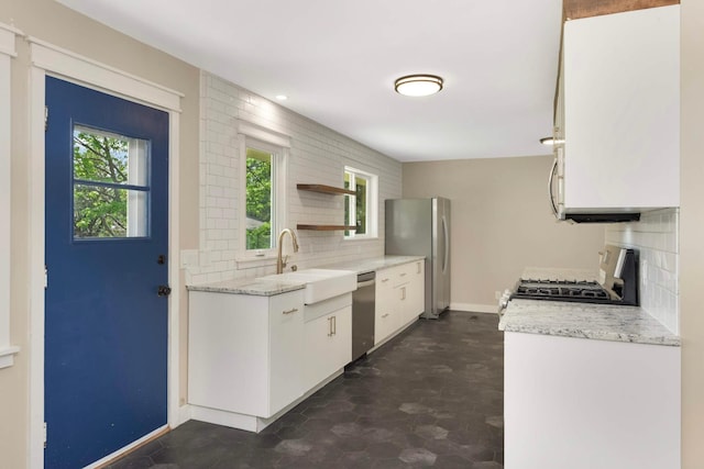 7609 65th Ave N, Brooklyn Park, MN 55428 - kitchen featuring stainless steel appliances, a sink, backsplash, open shelves, and white cabinetry