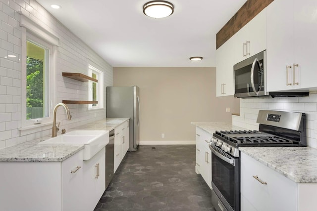 7609 65th Ave N, Brooklyn Park, MN 55428 - kitchen featuring appliances with stainless steel finishes, a sink, open shelves, backsplash, and white cabinets