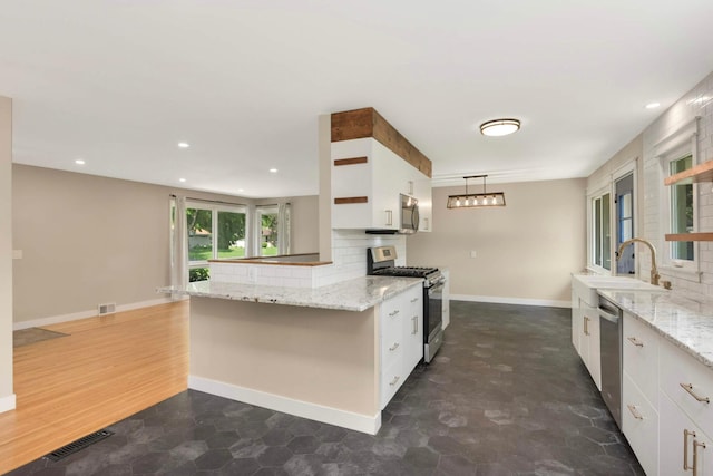 7609 65th Ave N, Brooklyn Park, MN 55428 - kitchen featuring stainless steel appliances, a sink, white cabinetry, baseboards, and decorative backsplash