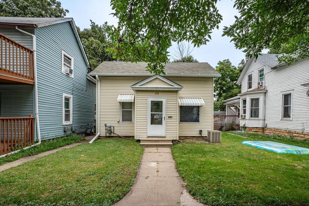 216 6th St, Red Wing, MN 55066 - view of front facade with a front yard and cooling unit
