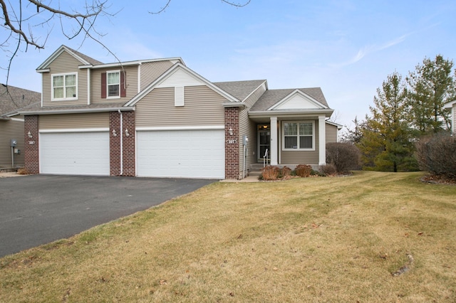 207 River Woods Dr W, Saint Paul Park, MN 55071 - view of front of property featuring asphalt driveway, brick siding, a front yard, and an attached garage