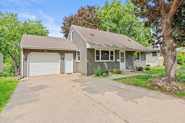 4618 Jefferson St NE, Columbia Heights, MN 55421 - view of front facade featuring a garage, driveway, and roof with shingles