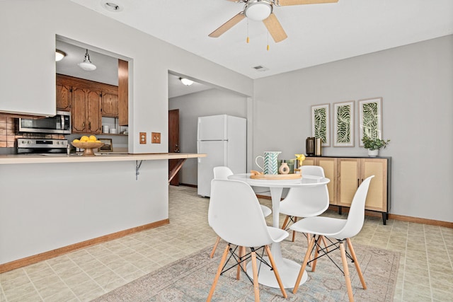 4618 Jefferson St NE, Columbia Heights, MN 55421 - dining room with light flooring, ceiling fan, and baseboards