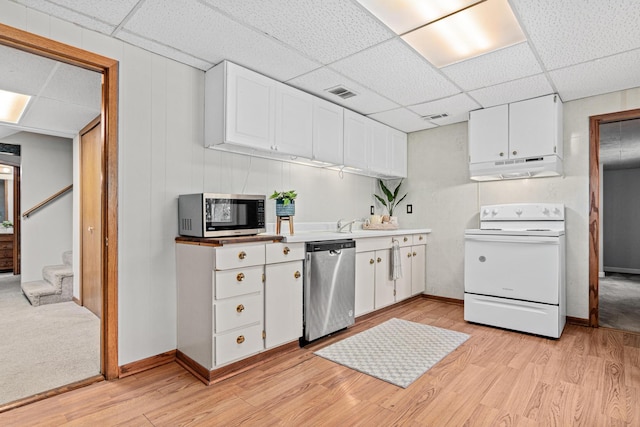 4618 Jefferson St NE, Columbia Heights, MN 55421 - kitchen featuring appliances with stainless steel finishes, under cabinet range hood, a paneled ceiling, light wood-style floors, and white cabinets