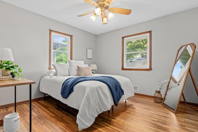 4618 Jefferson St NE, Columbia Heights, MN 55421 - bedroom with baseboards, light wood finished floors, and a ceiling fan