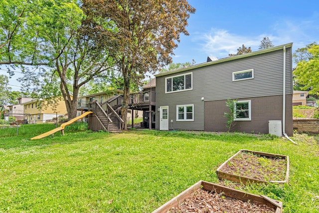 4618 Jefferson St NE, Columbia Heights, MN 55421 - back of house featuring a vegetable garden, stairway, a wooden deck, and a yard