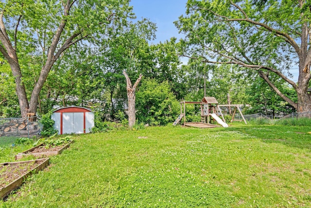 4618 Jefferson St NE, Columbia Heights, MN 55421 - view of yard with a playground, a garden, and view of wooded area