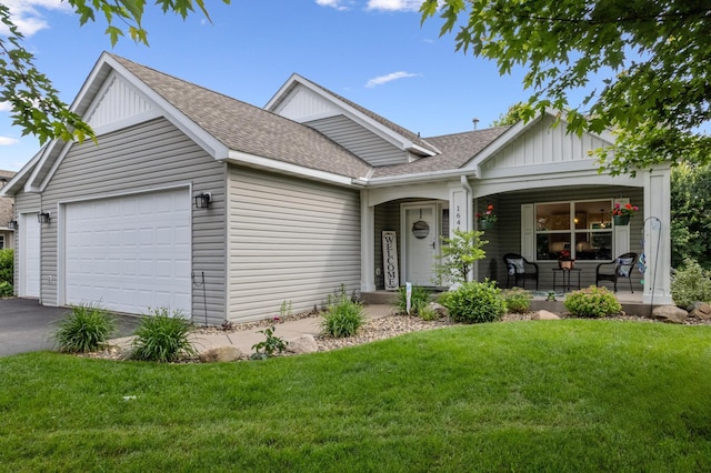 1641 Possum Way, New Richmond, WI 54017 - ranch-style home with a porch, roof with shingles, a front lawn, and an attached garage