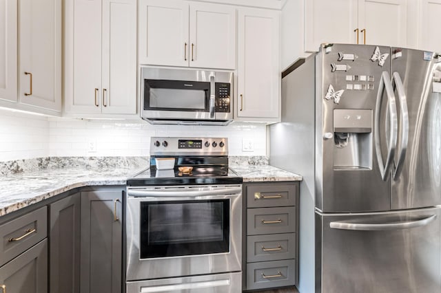 1641 Possum Way, New Richmond, WI 54017 - kitchen with stainless steel appliances, tasteful backsplash, light stone countertops, and gray cabinetry