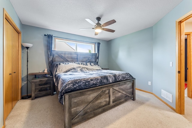 1641 Possum Way, New Richmond, WI 54017 - carpeted bedroom with a textured ceiling, ceiling fan, and a closet