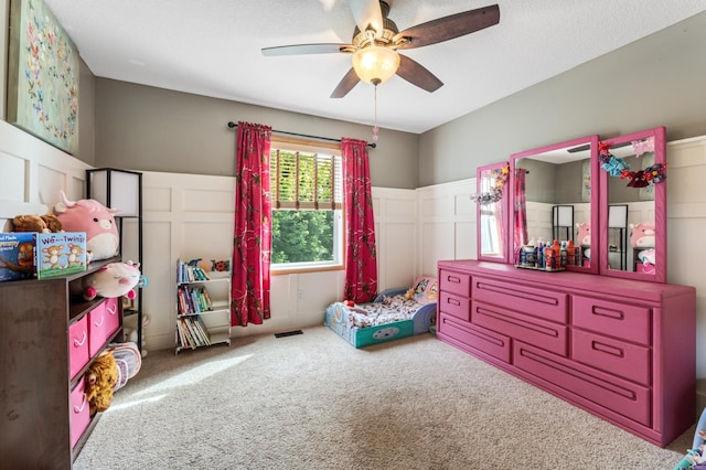 1641 Possum Way, New Richmond, WI 54017 - carpeted bedroom with a decorative wall, a wainscoted wall, and a ceiling fan