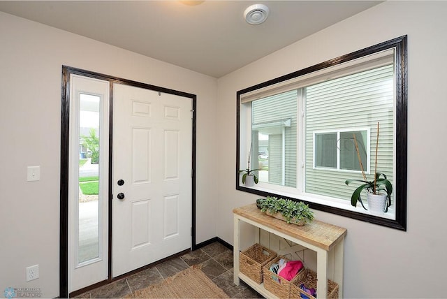 5962 57th Ave S, Fargo, ND 58104 - entryway featuring baseboards and dark stone finish flooring