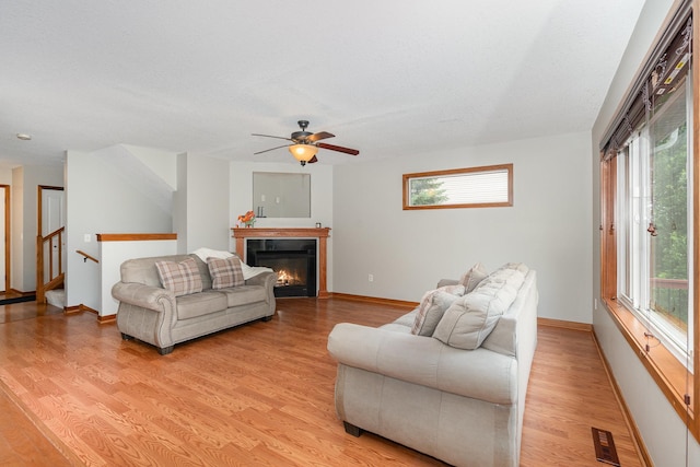 29259 Wildwood Rd, Chisago City, MN 55013 - living room featuring healthy amount of natural light, light wood finished floors, and a ceiling fan