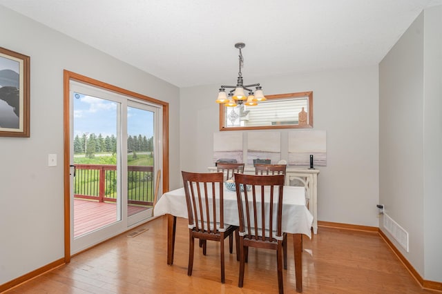 29259 Wildwood Rd, Chisago City, MN 55013 - dining area featuring a chandelier and light wood-type flooring