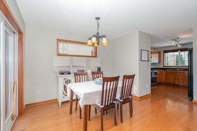 29259 Wildwood Rd, Chisago City, MN 55013 - dining space with light wood-type flooring and a chandelier