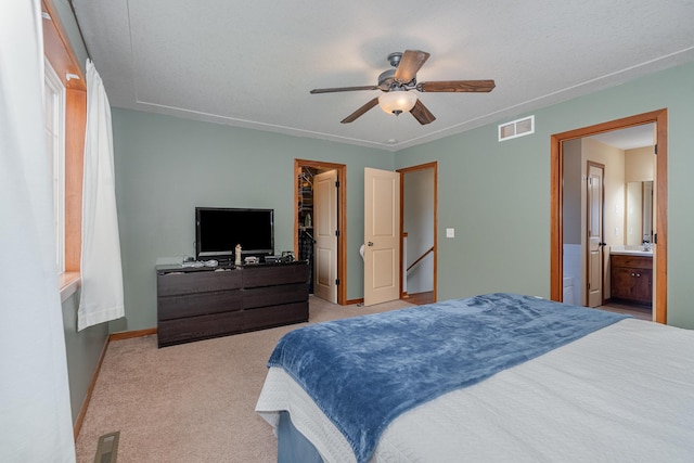 29259 Wildwood Rd, Chisago City, MN 55013 - bedroom with a walk in closet, light carpet, a closet, ensuite bath, and ceiling fan