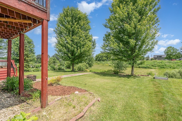 29259 Wildwood Rd, Chisago City, MN 55013 - view of green lawn featuring a fire pit and a wooden deck