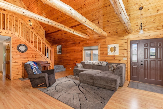 W7340 163rd Ave, Hager City, WI 54014 - living area featuring healthy amount of natural light, wood finished floors, a wooden ceiling with exposed beams, stairs, and wood walls