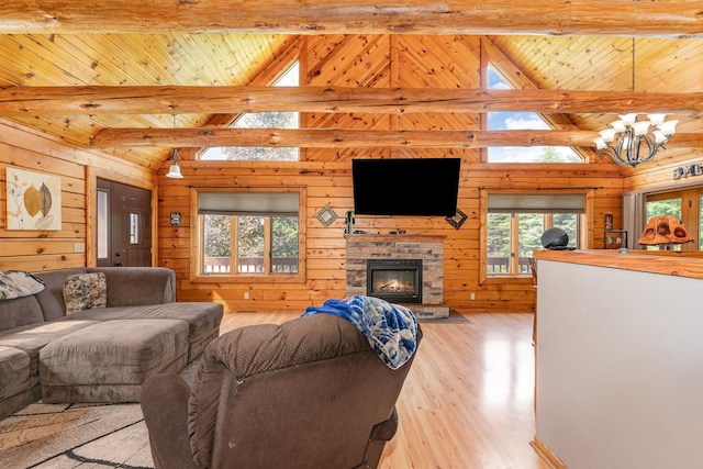 W7340 163rd Ave, Hager City, WI 54014 - living room featuring healthy amount of natural light, wood walls, light wood-type flooring, a chandelier, and wooden ceiling