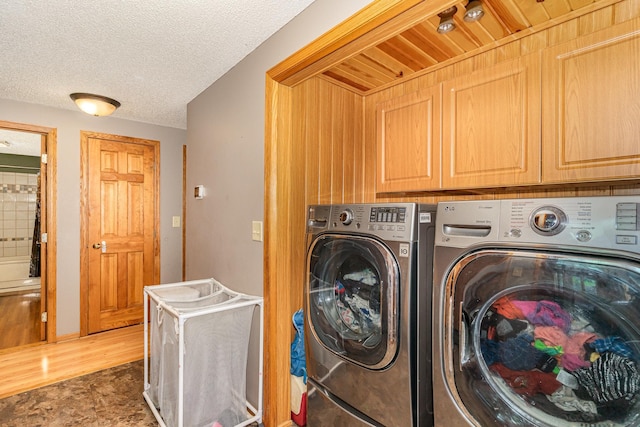 W7340 163rd Ave, Hager City, WI 54014 - washroom featuring cabinet space, separate washer and dryer, and a textured ceiling