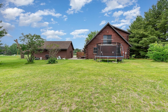 W7340 163rd Ave, Hager City, WI 54014 - rear view of house featuring a trampoline, a lawn, and log exterior