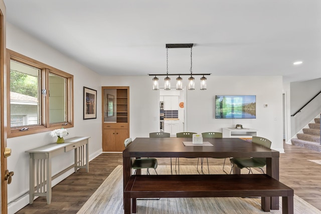 8401 Meadow Lake Rd N, New Hope, MN 55428 - dining space featuring a baseboard heating unit, stairway, dark wood-style floors, baseboards, and recessed lighting